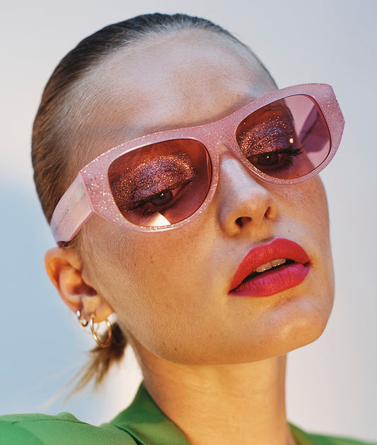 Desire-pleasure-glitter-pink-sunglasses-with-glitter-on-model