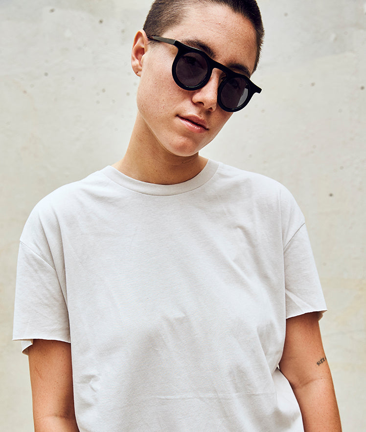 Lind-midnight-black-tinted-round-sunglasses-on-model